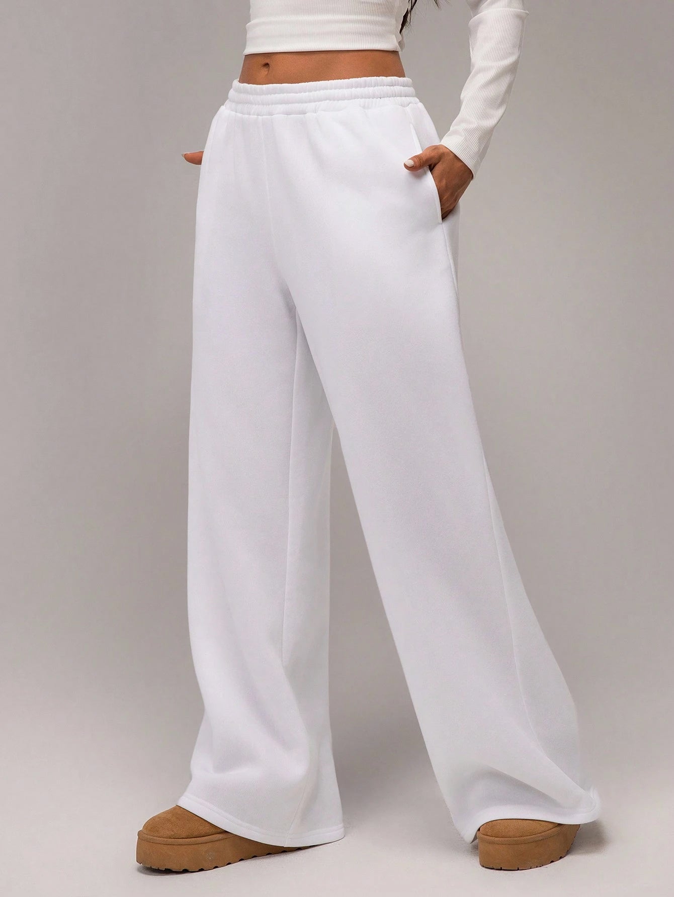White wide-leg pants worn by a person on a plain background